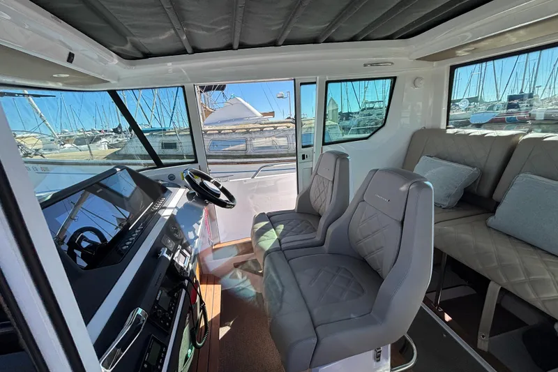 Slide: The Image of Interior of 2022 Axopar 28 AFT CABIN with modern seating and dashboard. - 17