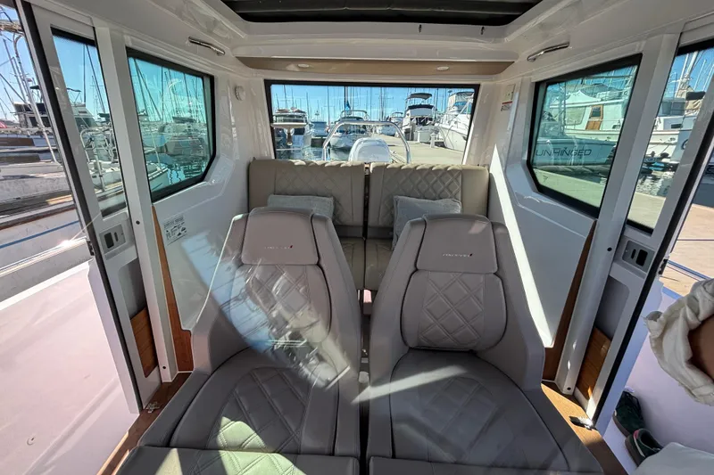 Slide: The Image of Interior of 2022 Axopar 28 AFT CABIN, featuring luxurious seating and panoramic windows. - 18
