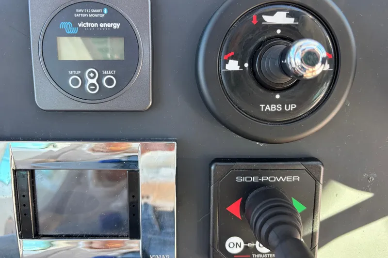 Slide: The Image of Control panel of 2022 Axopar 28 AFT CABIN with battery monitor and thruster controls. - 26