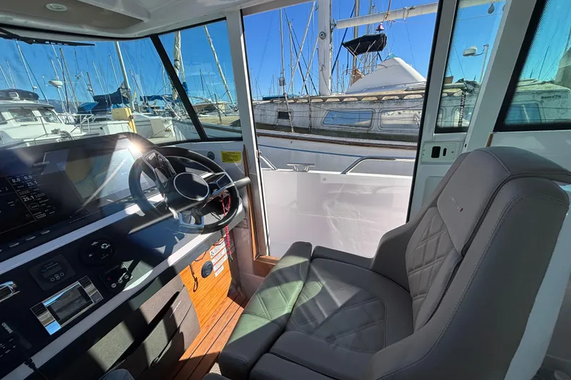 Slide: The Image of Interior view of 2022 Axopar 28 AFT CABIN boat with helm and seating. - 27