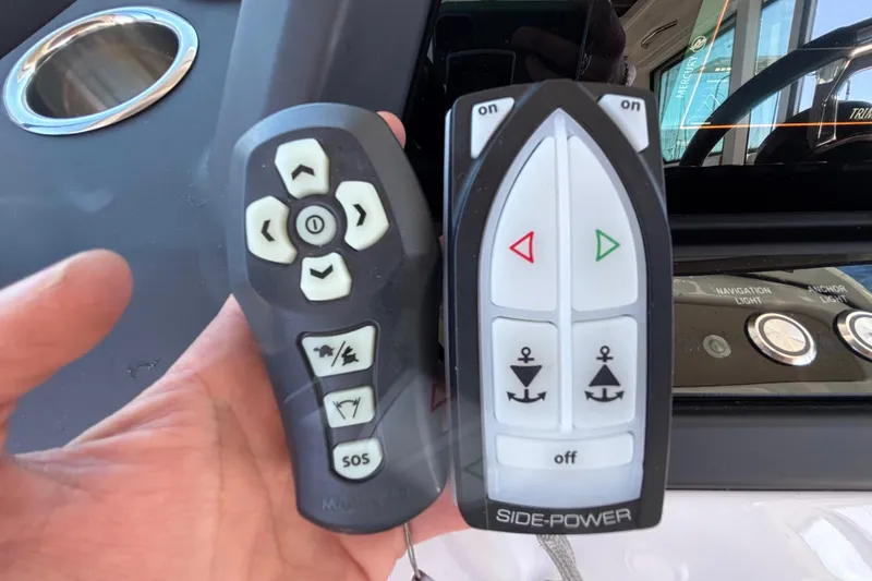 Slide: The Image of Remote controls for Axopar 28 AFT CABIN 2022, featuring navigation and anchor functions. - 30