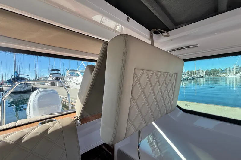 Slide: The Image of Interior view of 2022 Axopar 28 AFT CABIN with marina backdrop. - 34