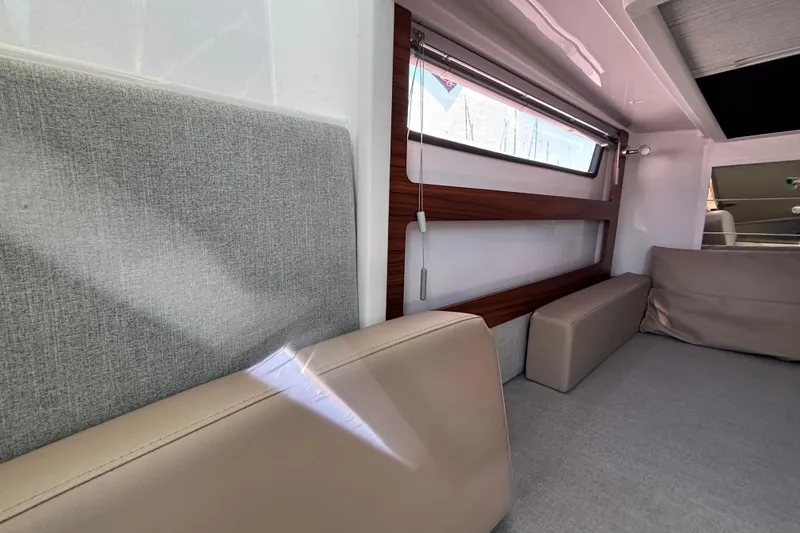 Slide: The Image of Interior of 2022 Axopar 28 AFT CABIN with modern seating and window design. - 38