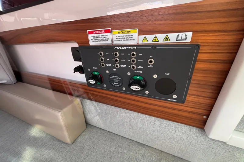 Slide: The Image of Control panel in 2022 Axopar 28 AFT CABIN, featuring various switches and indicators. - 39
