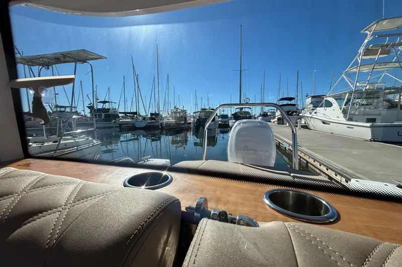 Slide: The Image of Interior view from 2022 Axopar 28 AFT CABIN, overlooking marina with docked boats. - 40