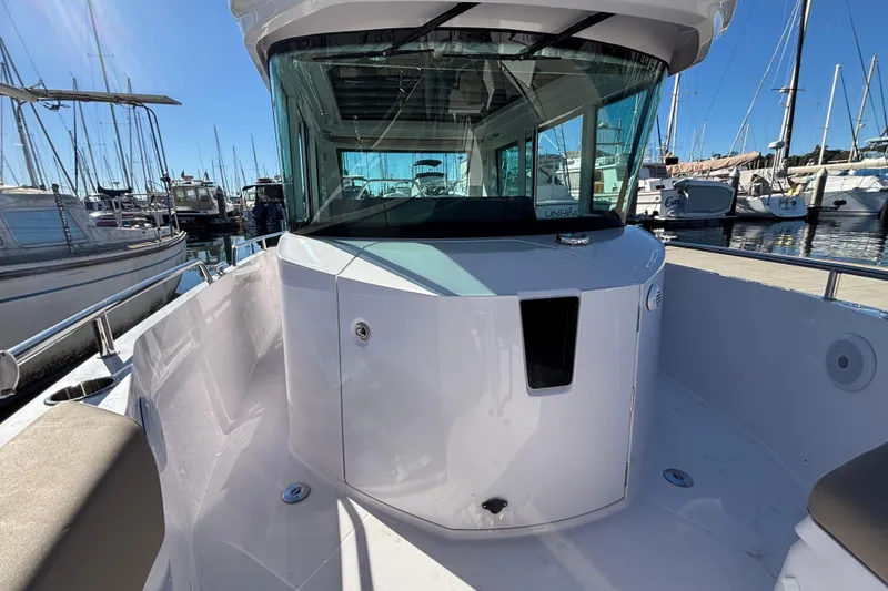 Slide: The Image of 2022 Axopar 28 AFT CABIN boat docked at marina, showcasing sleek design and spacious cabin. - 44