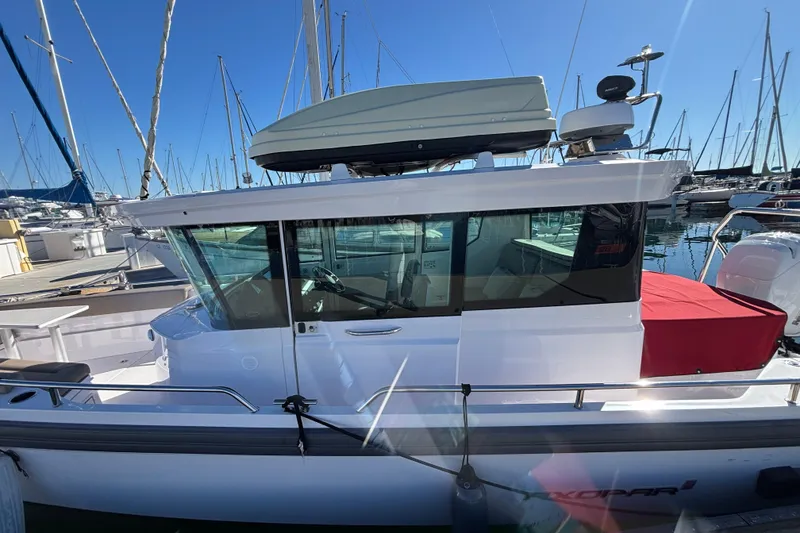 Slide: The Image of 2022 Axopar 28 AFT CABIN boat docked at marina, side view. - 5
