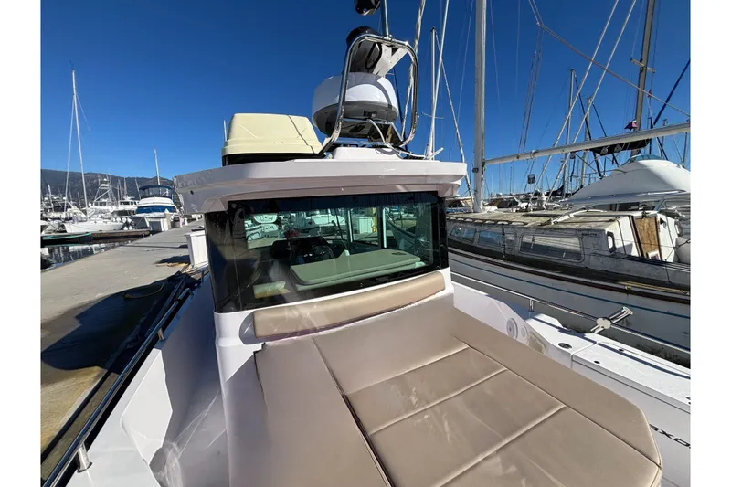 Slide: The Image of 2022 Axopar 28 AFT CABIN boat docked at marina under clear blue sky. - 9