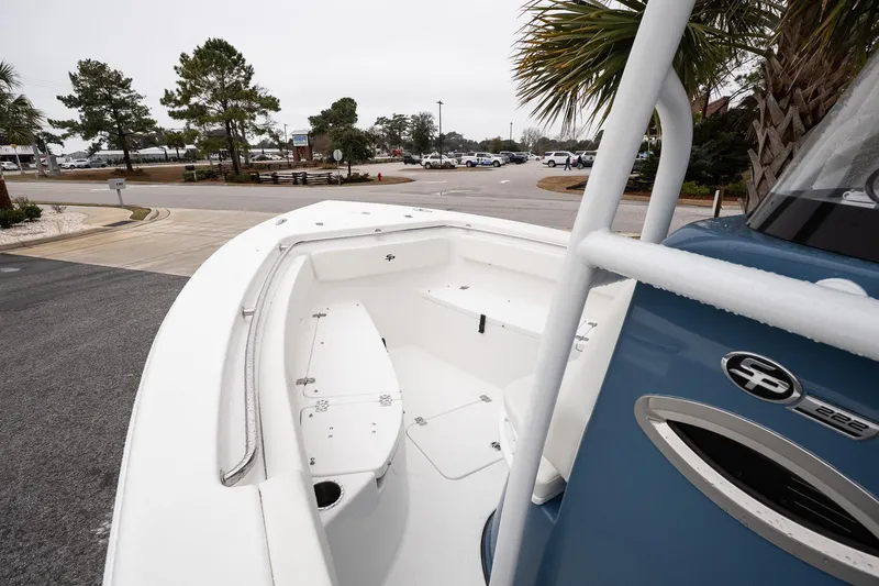Slide: The Image of 2026 Sea Pro 222 Center Console boat parked near palm trees and road. - 12