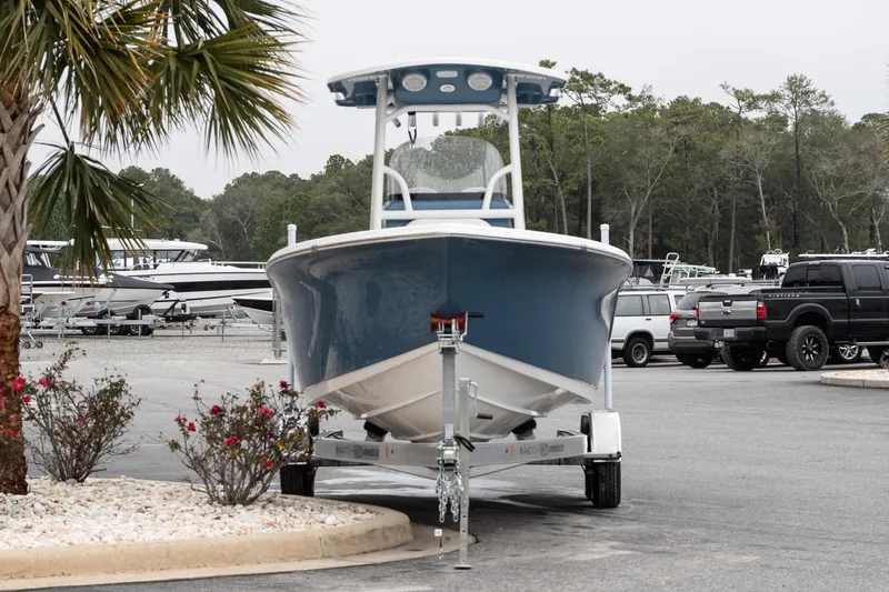 Slide: The Image of 2026 Sea Pro 222 Center Console boat on trailer in parking lot with trees. - 4