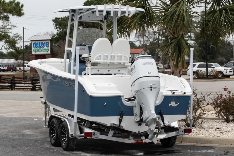 Slide: The Image of 2026 Sea Pro 222 Center Console boat on trailer, parked near palm trees. - 5