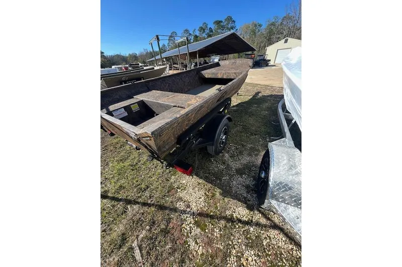 Slide: The Image of 2026 G3 Gator Tough 15 FL boat on trailer, outdoors in a yard setting. - 2