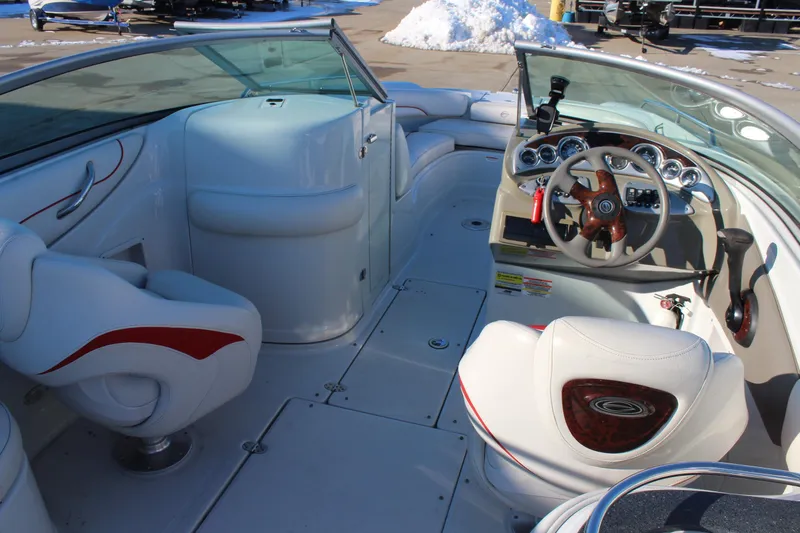 Slide: The Image of 2007 Crownline 240 EX boat interior with steering wheel and seating. - 11