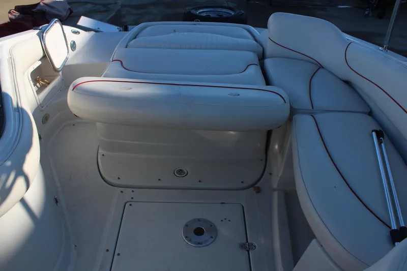 Slide: The Image of 2007 Crownline 240 EX boat interior with white seating and red trim. - 12