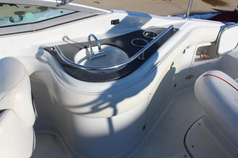 Slide: The Image of 2007 Crownline 240 EX boat interior with sink and cup holders. - 13