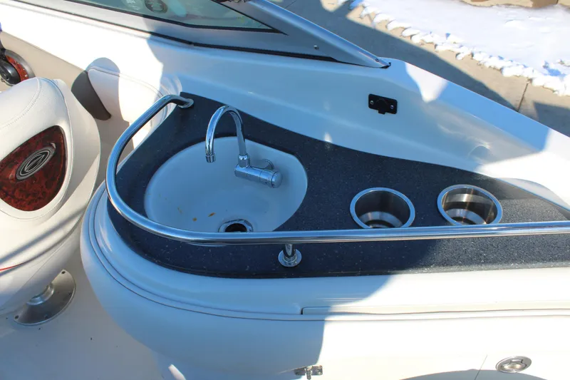 Slide: The Image of 2007 Crownline 240 EX boat interior with sink and cup holders. - 14
