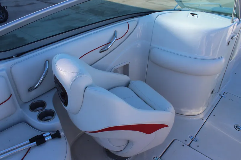 Slide: The Image of 2007 Crownline 240 EX boat interior with white seating and red accents. - 16