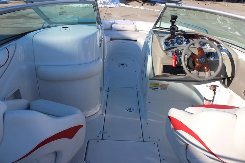 Slide: The Image of 2007 Crownline 240 EX boat interior with white seating and modern dashboard. - 17
