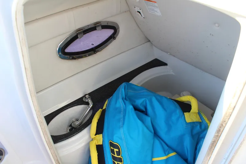 Slide: The Image of 2007 Crownline 240 EX boat interior with sink and blue life jacket. - 19