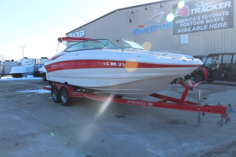 Slide: The Image of 2007 Crownline 240 EX boat on red trailer at dealership lot. - 2