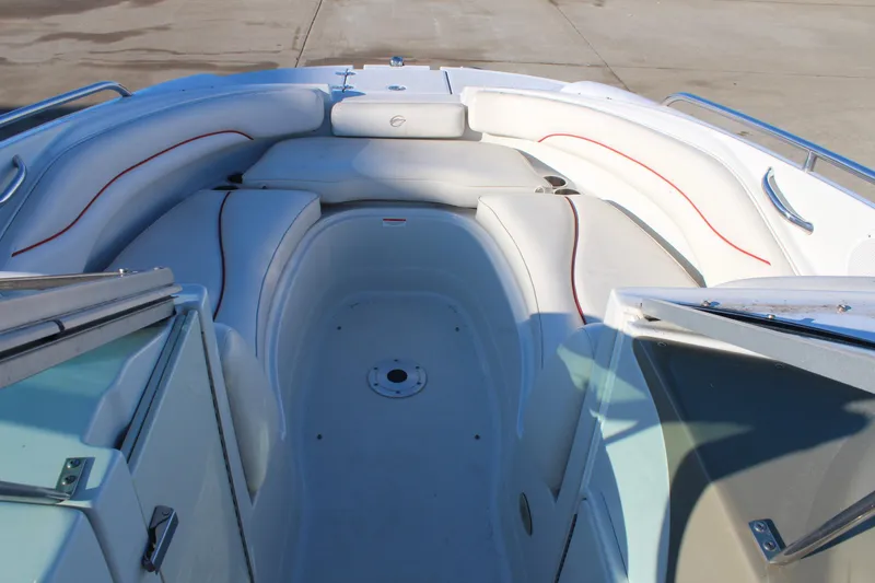 Slide: The Image of 2007 Crownline 240 EX boat interior with white seating and red accents. - 21