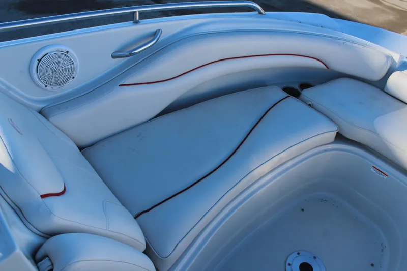 Slide: The Image of 2007 Crownline 240 EX boat interior with white seating and speaker. - 22