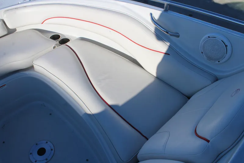 Slide: The Image of 2007 Crownline 240 EX boat interior with white seating and red accents. - 23