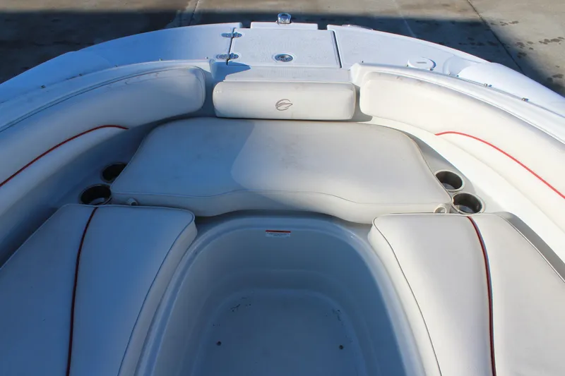 Slide: The Image of 2007 Crownline 240 EX boat interior with white seating and cup holders. - 24
