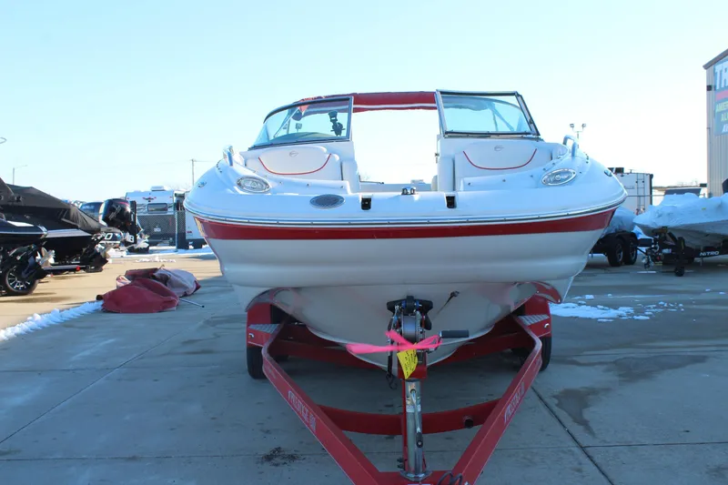 Slide: The Image of 2007 Crownline 240 EX boat on trailer, parked outdoors in a marina. - 3