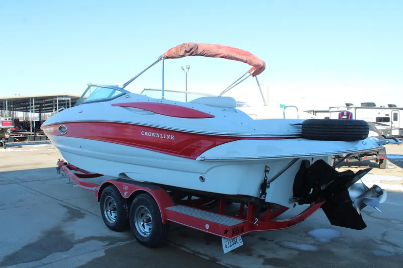 Slide: The Image of 2007 Crownline 240 EX boat on trailer, red and white design, parked outdoors. - 6