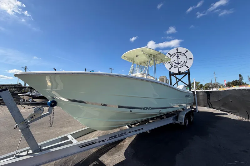 Slide: The Image of 2025 Bulls Bay 255 Center Console boat on trailer under clear blue sky. - 13