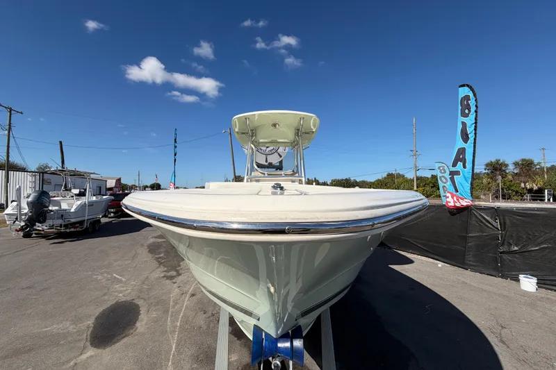 Slide: The Image of 2025 Bulls Bay 255 Center Console boat displayed outdoors under clear blue sky. - 15