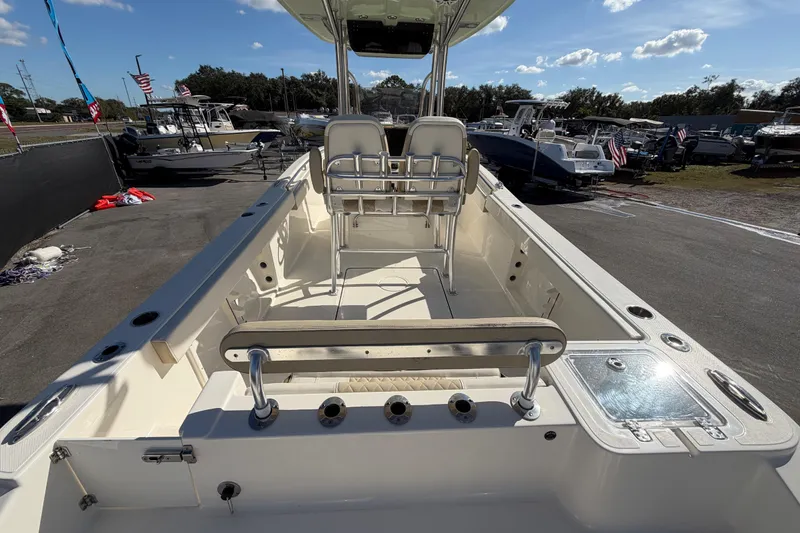 Slide: The Image of 2025 Bulls Bay 255 Center Console boat interior with seating and fishing rod holders. - 17