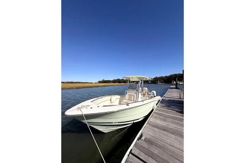 Slide: The Image of 2025 Bulls Bay 255 Center Console boat on trailer with Yamaha engine, under clear blue sky. - 2