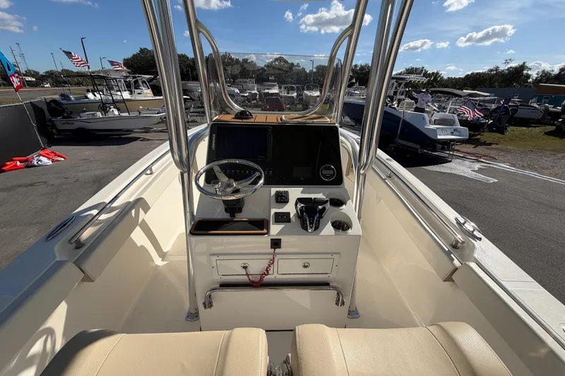 Slide: The Image of 2025 Bulls Bay 255 Center Console boat interior with steering wheel and control panel. - 26