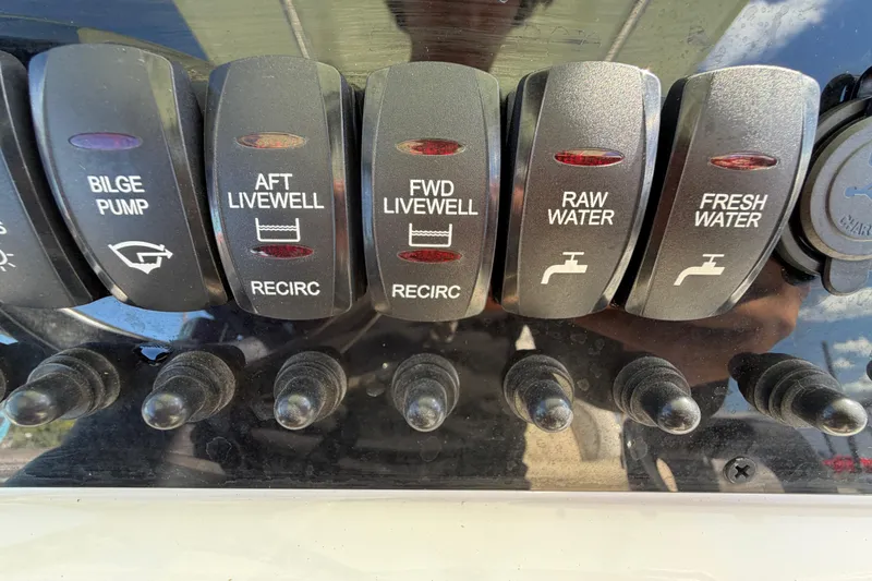 Slide: The Image of Control panel of 2025 Bulls Bay 255 Center Console boat with labeled switches. - 30