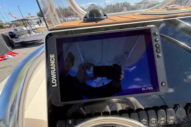 Slide: The Image of Control panel of 2025 Bulls Bay 255 Center Console boat with various switches. - 31