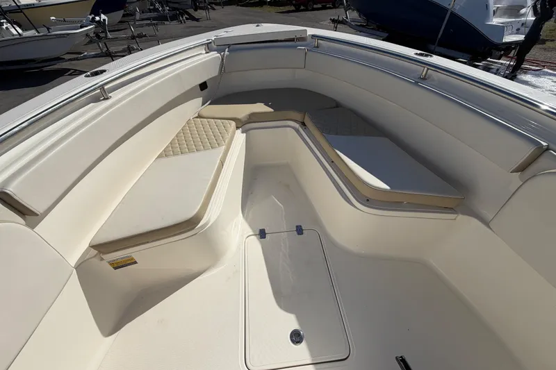 Slide: The Image of 2025 Bulls Bay 255 Center Console boat interior with cushioned seating and stainless steel railings. - 48