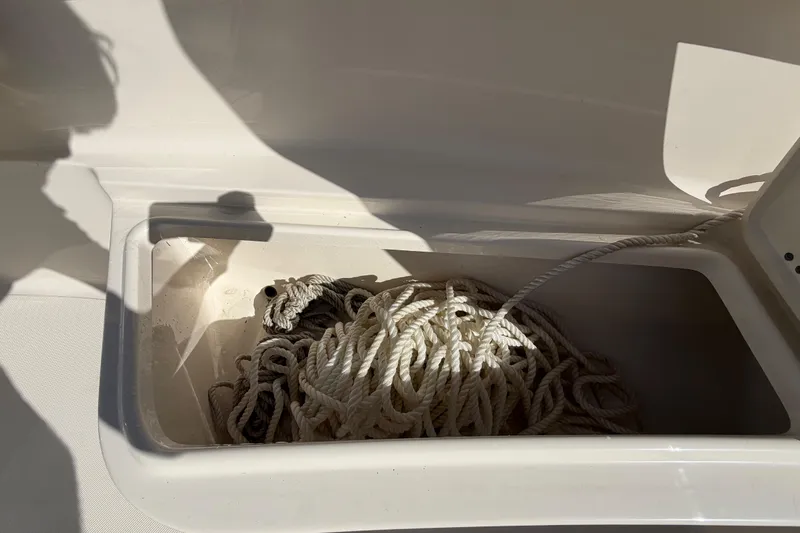 Slide: The Image of 2025 Bulls Bay 255 Center Console boat interior with storage compartment and seating. - 54