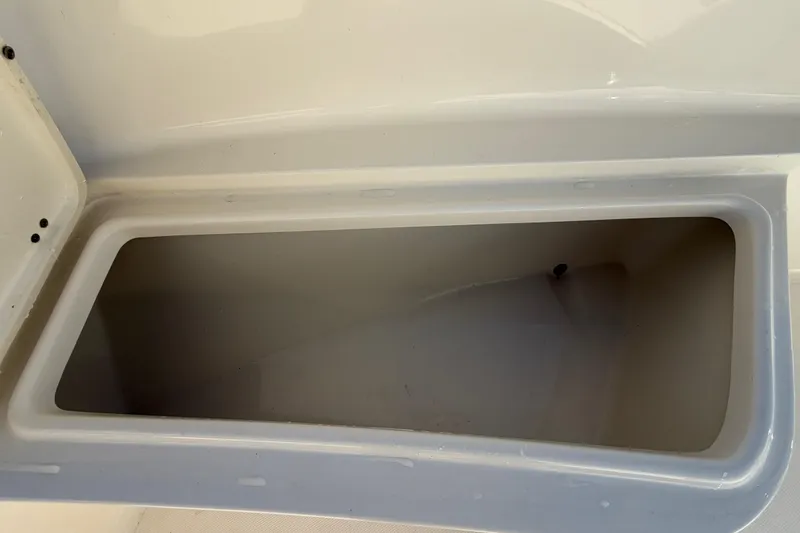 Slide: The Image of 2025 Bulls Bay 255 Center Console boat storage compartment with cushioned seating. - 57
