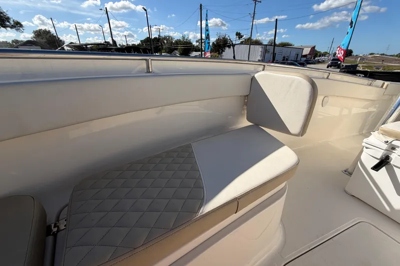 Slide: The Image of 2025 Bulls Bay 255 Center Console boat interior with cushioned seating and storage. - 65
