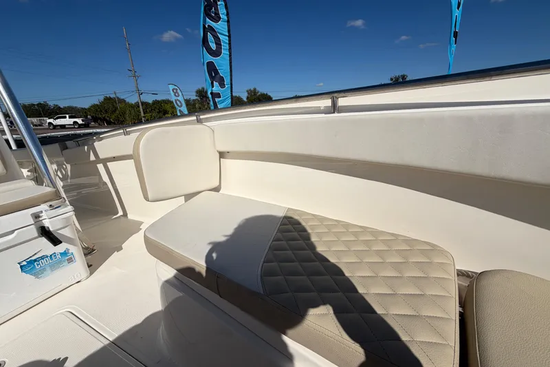 Slide: The Image of 2025 Bulls Bay 255 Center Console boat interior with cushioned seating and cooler. - 67