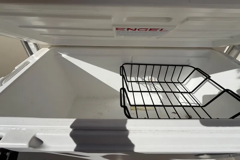 Slide: The Image of 2025 Bulls Bay 255 Center Console boat interior with cushioned seating and storage. - 69