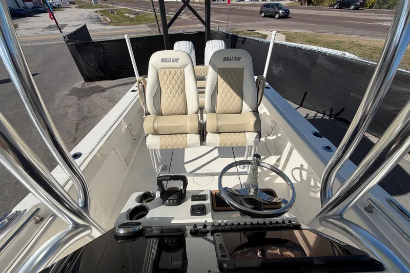 Slide: The Image of 2025 Bulls Bay 255 Center Console boat interior with steering wheel and seating. - 71