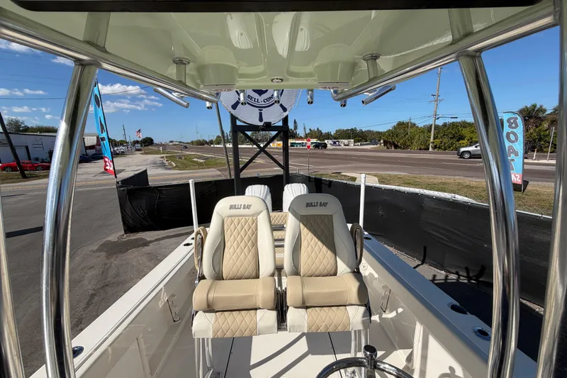 Slide: The Image of 2025 Bulls Bay 255 Center Console boat interior with steering wheel and seating. - 72