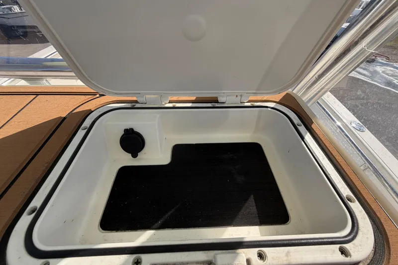 Slide: The Image of Open storage compartment on 2025 Bulls Bay 255 Center Console boat. - 74