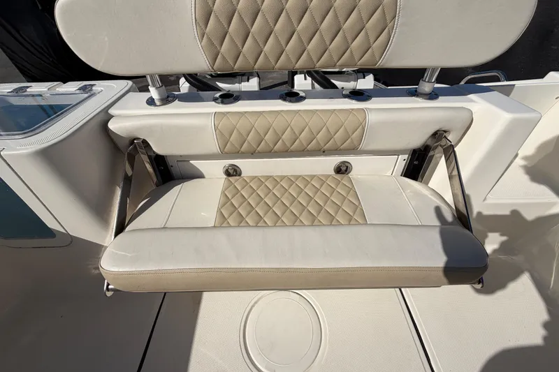 Slide: The Image of 2025 Bulls Bay 255 Center Console boat seating with diamond-stitched upholstery and cup holders. - 80