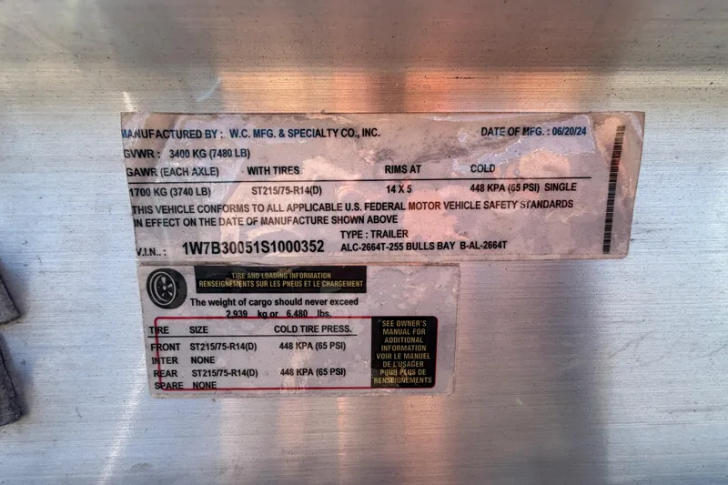 Slide: The Image of Trailer wheels for 2025 Bulls Bay 255 Center Console boat on asphalt. - 82