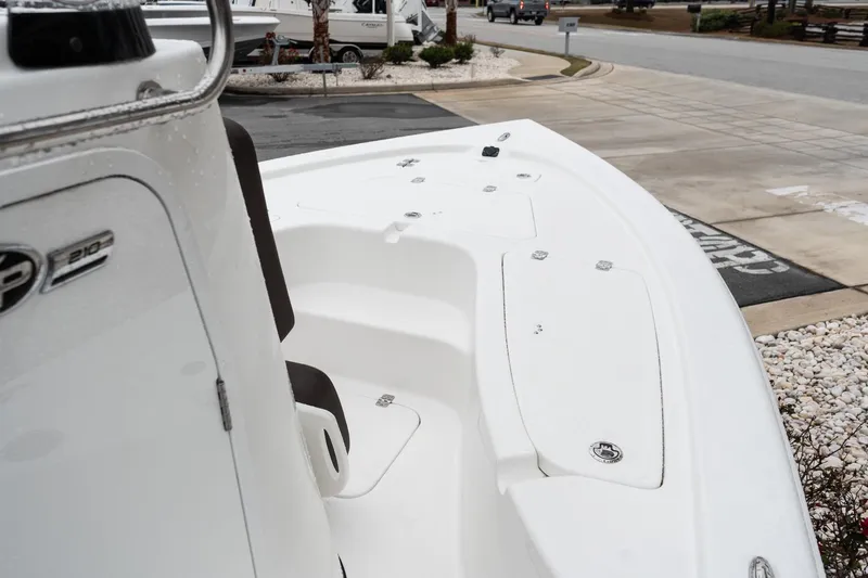 Slide: The Image of 2026 Sea Pro 210 Bay boat seat with logo, featuring a Suzuki engine in the background. - 12