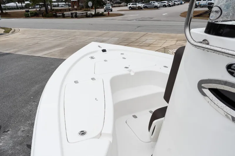 Slide: The Image of 2026 Sea Pro 210 Bay boat seat with Suzuki engine in background. - 13